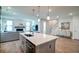 Spacious kitchen with a large island, seamlessly flowing into the living room with fireplace and staircase at 312 Clearpath Dr, Summerville, SC 29486