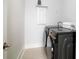 Modern laundry room featuring dark, front-loading washer and dryer with a folding shelf and tile floors at 312 Clearpath Dr, Summerville, SC 29486