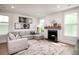 Bright living room with a cozy fireplace, plush seating, and elegant decor at 312 Clearpath Dr, Summerville, SC 29486