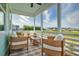 Relaxing screened-in porch with wicker furniture and a view of the neighborhood at 312 Clearpath Dr, Summerville, SC 29486