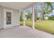 Covered back porch with concrete floor, white pillars, and a view of the grassy backyard at 3214 Pinewood Dr, Ladson, SC 29456