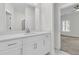 Bright bathroom vanity with white cabinets, a large mirror and a door to the bedroom at 3214 Pinewood Dr, Ladson, SC 29456