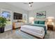 Bright bedroom features a large window, a modern dresser with a TV, and stylish decor at 3214 Pinewood Dr, Ladson, SC 29456