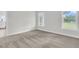 Cozy bedroom with plush carpeting and two windows providing natural light at 3214 Pinewood Dr, Ladson, SC 29456