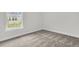 Bedroom with neutral carpet, base trim, and a large window view at 3214 Pinewood Dr, Ladson, SC 29456