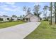 New home showcasing a one-car garage and a modern concrete driveway for added convenience at 3214 Pinewood Dr, Ladson, SC 29456