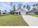 Inviting single-story home featuring a well-manicured lawn, one-car garage, and a concrete driveway at 3214 Pinewood Dr, Ladson, SC 29456