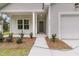 Inviting front of home featuring well-maintained landscaping, a concrete walkway, and a garage at 3214 Pinewood Dr, Ladson, SC 29456