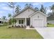 Charming single-story home with gray siding, a garage, and a well-manicured front yard at 3214 Pinewood Dr, Ladson, SC 29456