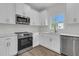 Well-lit kitchen showcases stainless steel appliances, quartz countertops and white cabinets at 3214 Pinewood Dr, Ladson, SC 29456