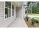 Beautiful exterior featuring a covered porch with white columns, perfect for relaxing and enjoying the outdoors at 3214 Pinewood Dr, Ladson, SC 29456