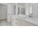Modern bathroom showcasing double sink vanity with white countertop, cabinets, and brushed-nickel hardware and marble floors at 3218 Pinewood Dr, Ladson, SC 29456