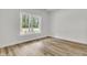 Bedroom with wood-look flooring, white trim and windows with lots of natural light at 3218 Pinewood Dr, Ladson, SC 29456