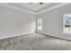 Carpeted bedroom with natural light, featuring a ceiling fan and neutral color palette at 3218 Pinewood Dr, Ladson, SC 29456