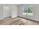Bedroom boasts wood-look flooring, white trim and neutral walls, complemented by natural light at 3218 Pinewood Dr, Ladson, SC 29456
