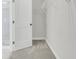 A walk-in closet with bright lighting, light gray carpet, and white wire shelving and racks at 3218 Pinewood Dr, Ladson, SC 29456