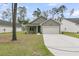 Charming single-Gathering home with a well-manicured lawn and attached two-car garage at 3218 Pinewood Dr, Ladson, SC 29456