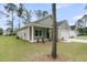 Exterior side view of the home's entrance, window and a lush yard at 3218 Pinewood Dr, Ladson, SC 29456