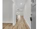 Inviting hallway with light wood floors leading to a bright living area and backyard at 3218 Pinewood Dr, Ladson, SC 29456
