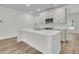Bright kitchen featuring a large center island with quartz countertops and stainless steel appliances at 3218 Pinewood Dr, Ladson, SC 29456