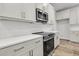 Modern kitchen featuring stainless steel microwave, quartz countertops, and light gray shaker style cabinets at 3218 Pinewood Dr, Ladson, SC 29456