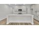 A spacious kitchen offers a central island with quartz countertop, stainless steel appliances and sleek cabinetry at 3218 Pinewood Dr, Ladson, SC 29456