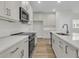 A stylish kitchen boasts stainless steel appliances, shaker cabinets and a quartz countertop island with sink at 3218 Pinewood Dr, Ladson, SC 29456