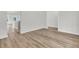 Open-concept living room with wood floors, white trim and walls, and lots of natural light at 3218 Pinewood Dr, Ladson, SC 29456