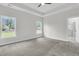 Spacious main bedroom with soft carpet, ceiling fan, tray ceiling and lots of natural light at 3218 Pinewood Dr, Ladson, SC 29456