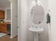 Powder room features a pedestal sink, oval mirror, and fixtures at 333 Flyway Rd, Goose Creek, SC 29445