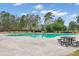 Large community pool with plenty of space for swimming, surrounded by lush greenery and tables at 333 Flyway Rd, Goose Creek, SC 29445