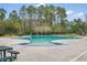Inviting community pool surrounded by lush greenery and picnic benches, perfect for relaxation and recreation at 333 Flyway Rd, Goose Creek, SC 29445