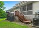 Charming home exterior featuring a screened porch with backyard access steps, and central air unit at 333 Flyway Rd, Goose Creek, SC 29445