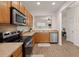 Well-lit kitchen features stainless steel appliances, wooden cabinets, and hardwood floors at 333 Flyway Rd, Goose Creek, SC 29445
