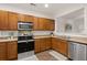 A kitchen showcasing wood cabinets, stainless steel appliances, and a dual basin sink at 333 Flyway Rd, Goose Creek, SC 29445