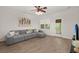 Bright living room with a gray sofa, ceiling fan, stylish décor, and hardwood floors at 333 Flyway Rd, Goose Creek, SC 29445