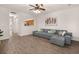 Inviting living room featuring a gray sofa, ceiling fan, stylish decor, and hardwood floors at 333 Flyway Rd, Goose Creek, SC 29445