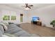 Bright living room with a TV, gray sofa, ceiling fan, stylish décor, and hardwood floors at 333 Flyway Rd, Goose Creek, SC 29445