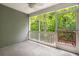 Relaxing screened porch with a ceiling fan and an idyllic view of the lush backyard and green trees at 333 Flyway Rd, Goose Creek, SC 29445