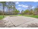 Outdoor sand volleyball court ready for a game, surrounded by green grass and tall trees at 333 Flyway Rd, Goose Creek, SC 29445