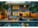 Inviting backyard showcases a pool, spa, deck with outdoor seating, and soft lighting for evening relaxation at 340 President St, Charleston, SC 29403