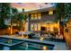 Inviting backyard showcasing a sleek pool, outdoor dining area, cozy seating around a fire pit and manicured landscaping at 340 President St, Charleston, SC 29403