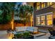 Relaxing backyard features a fire pit, modern furniture and privacy landscaping at 340 President St, Charleston, SC 29403