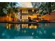Captivating backyard featuring a sparkling pool, elegant outdoor furniture, and ambient lighting for evening enjoyment at 340 President St, Charleston, SC 29403
