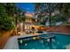 Charming backyard featuring a pool, jacuzzi, patio furniture, and lush tropical landscaping at 340 President St, Charleston, SC 29403