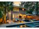 Beautiful backyard featuring a modern pool, outdoor seating, a fire pit, and lush landscaping for a serene retreat at 340 President St, Charleston, SC 29403