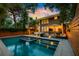 A backyard with a pool, hot tub, patio furniture, a privacy fence, and the exterior of the house at 340 President St, Charleston, SC 29403
