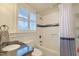 Bathroom with window and shower-tub combination with decorative shower curtain at 340 President St, Charleston, SC 29403