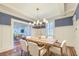 Traditional dining room with wood table, white chairs, wainscoting, and stylish chandelier at 340 President St, Charleston, SC 29403