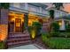 A red brick house with a porch and a lovely front yard with a sidewalk leading up to the steps at 340 President St, Charleston, SC 29403
